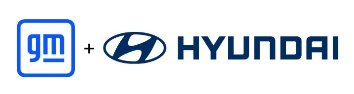 A silver convertible sports car parked near a scenic ocean vista.