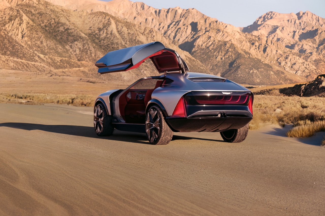 Exterior view of a futuristic off-road electric concept vehicle parked in a scenic desert area.