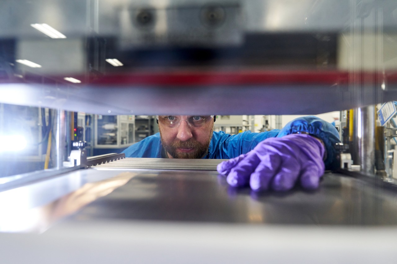 An employee holds a full-size prototype LMR battery cell