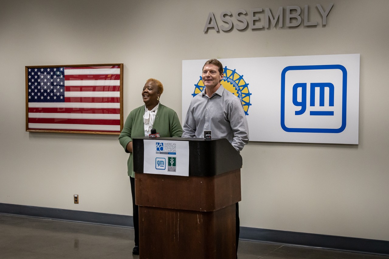 Ivy Tech Community College chancellor & Ft. Wayne Assembly plant leader stand at a podium to announce collaboration