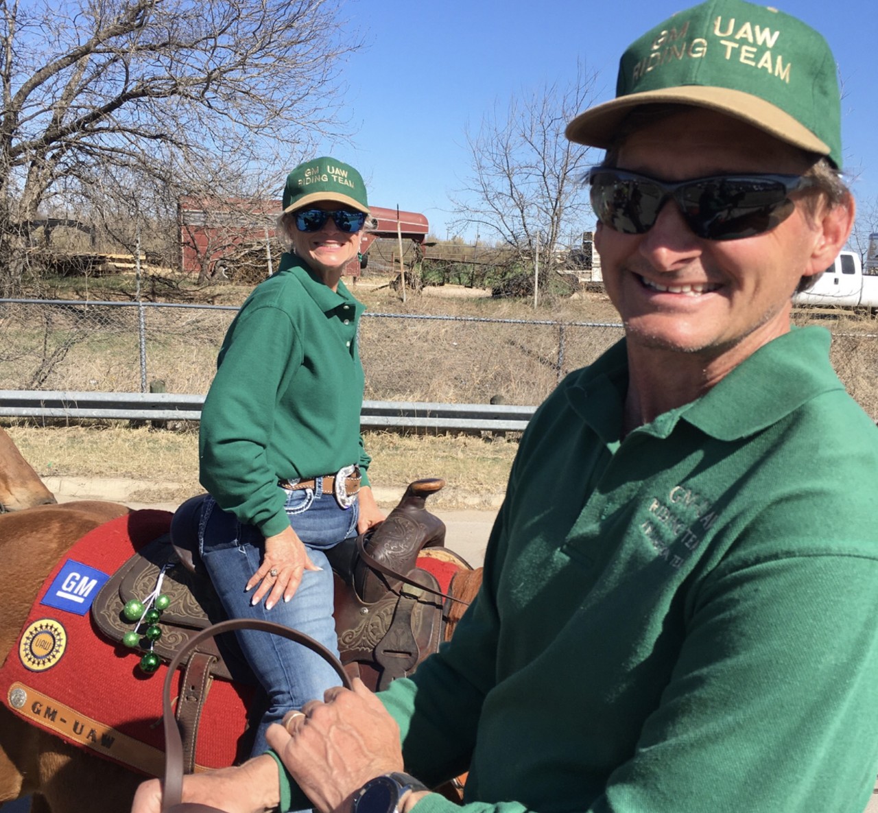 Two General Motors Team members riding brown horses in Texas.