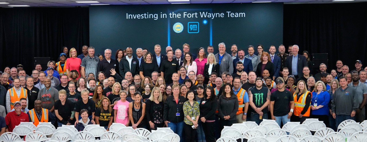 Fort Wayne employees pose with GM leadership after the investment announcement.