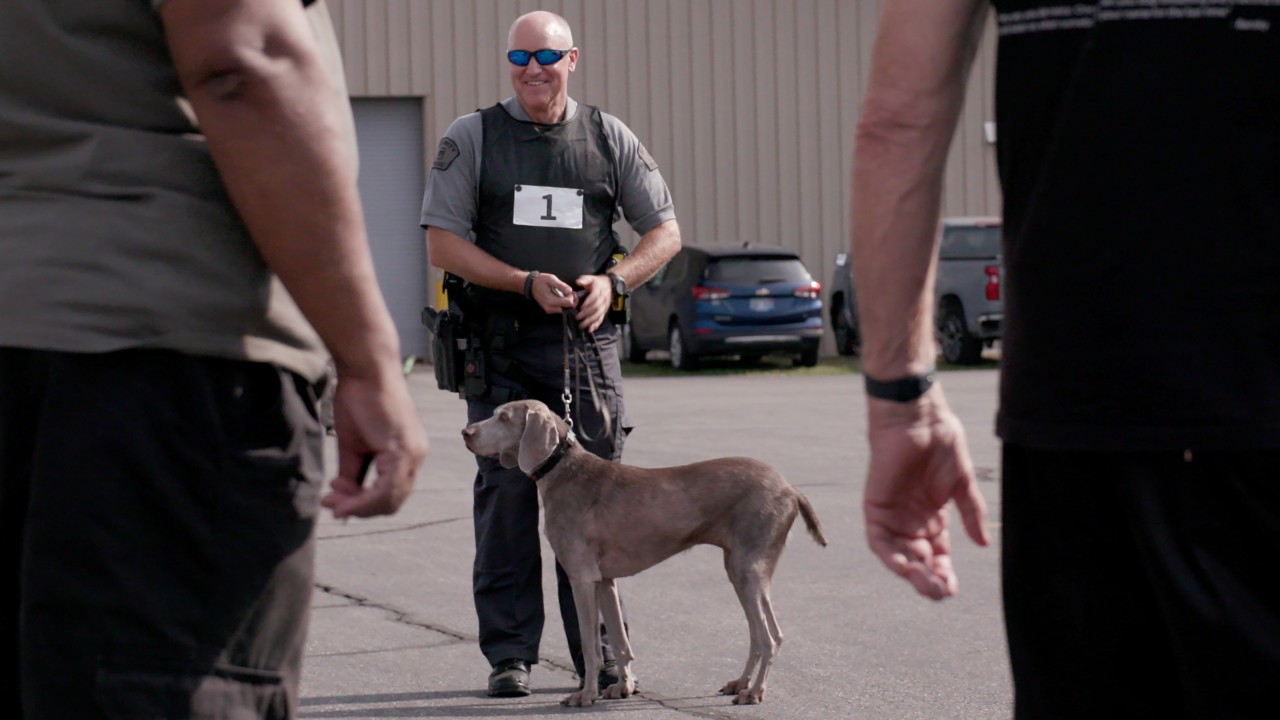 K9 Officer Rick holds Kasey's harness at the K9 recertification at Milford Proving Ground in October.