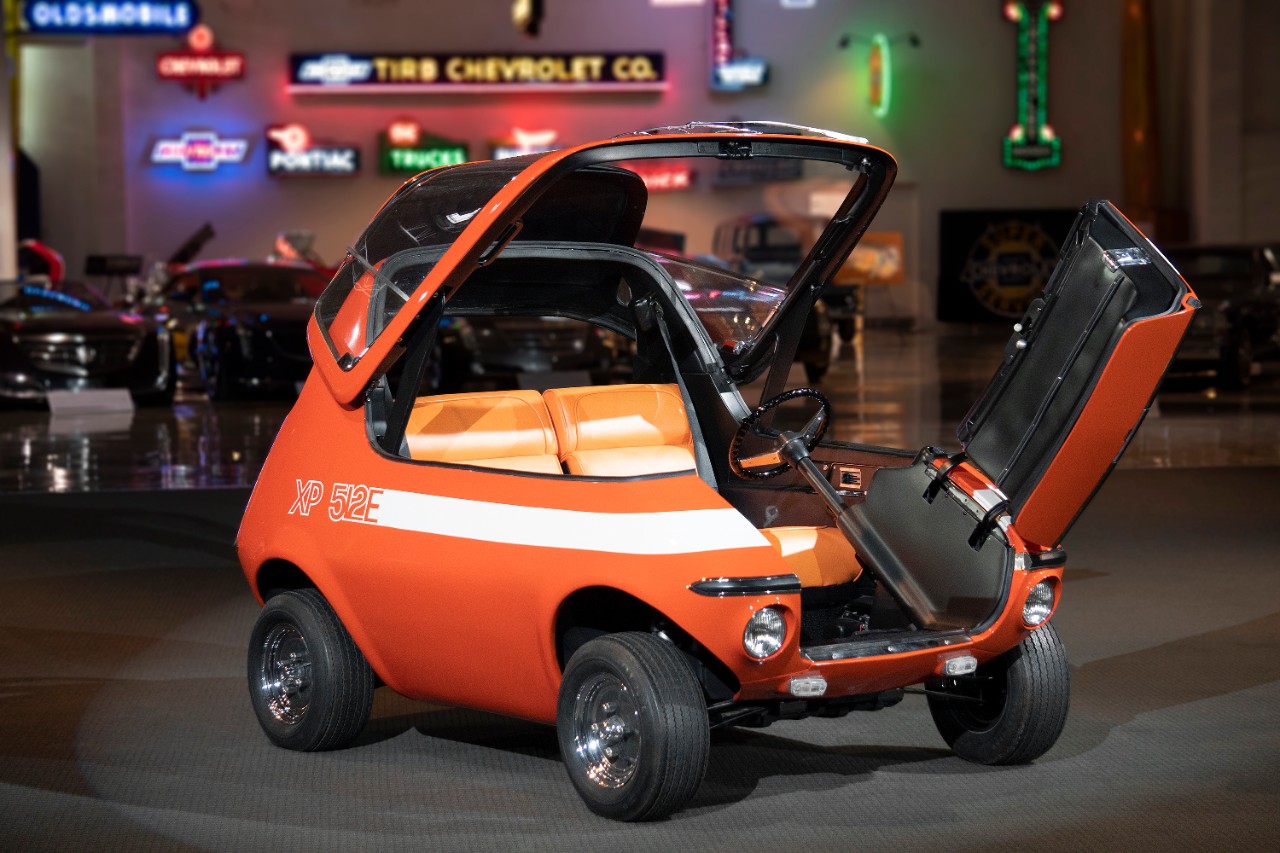 The GM 512E with the canopy top raised and front entry door opened.