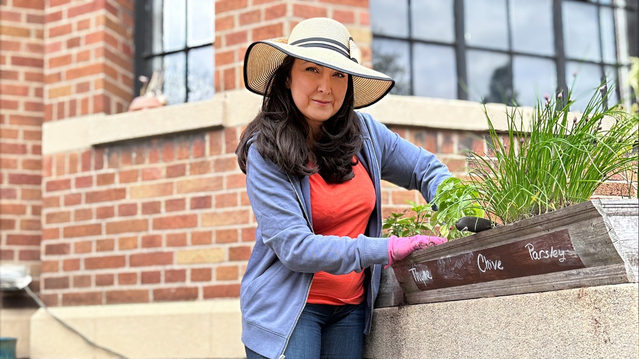 A woman tending plants in a garden