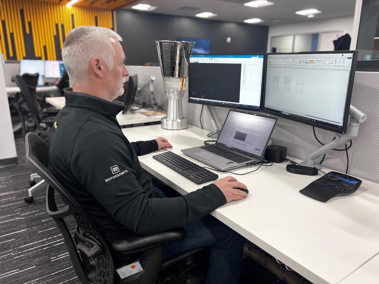 Anthony Heenan sitting at his desk in an office.