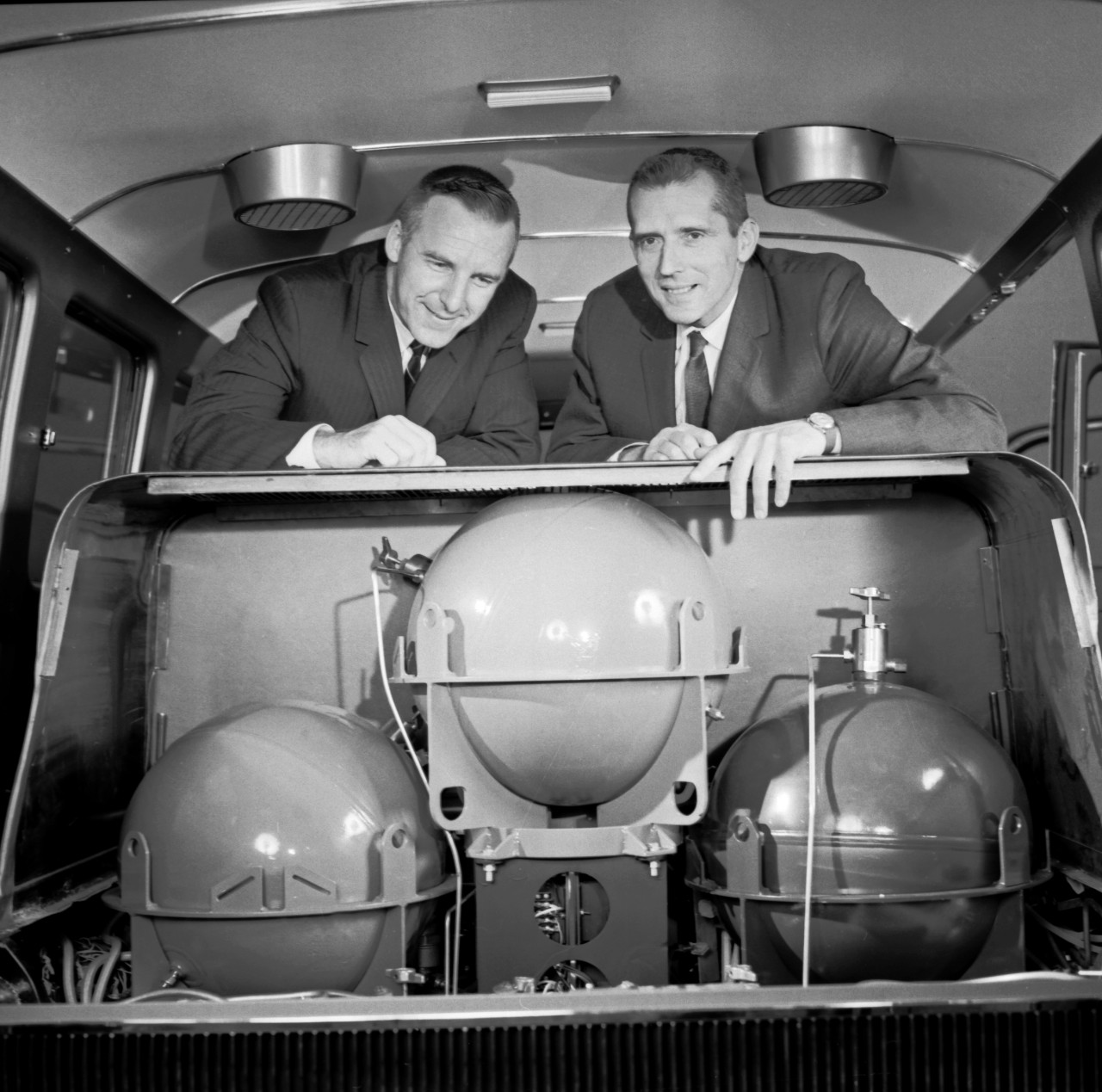 Craig Marks of GM and Charles Winters of Union Carbide examine the fuel system in the Electrovan