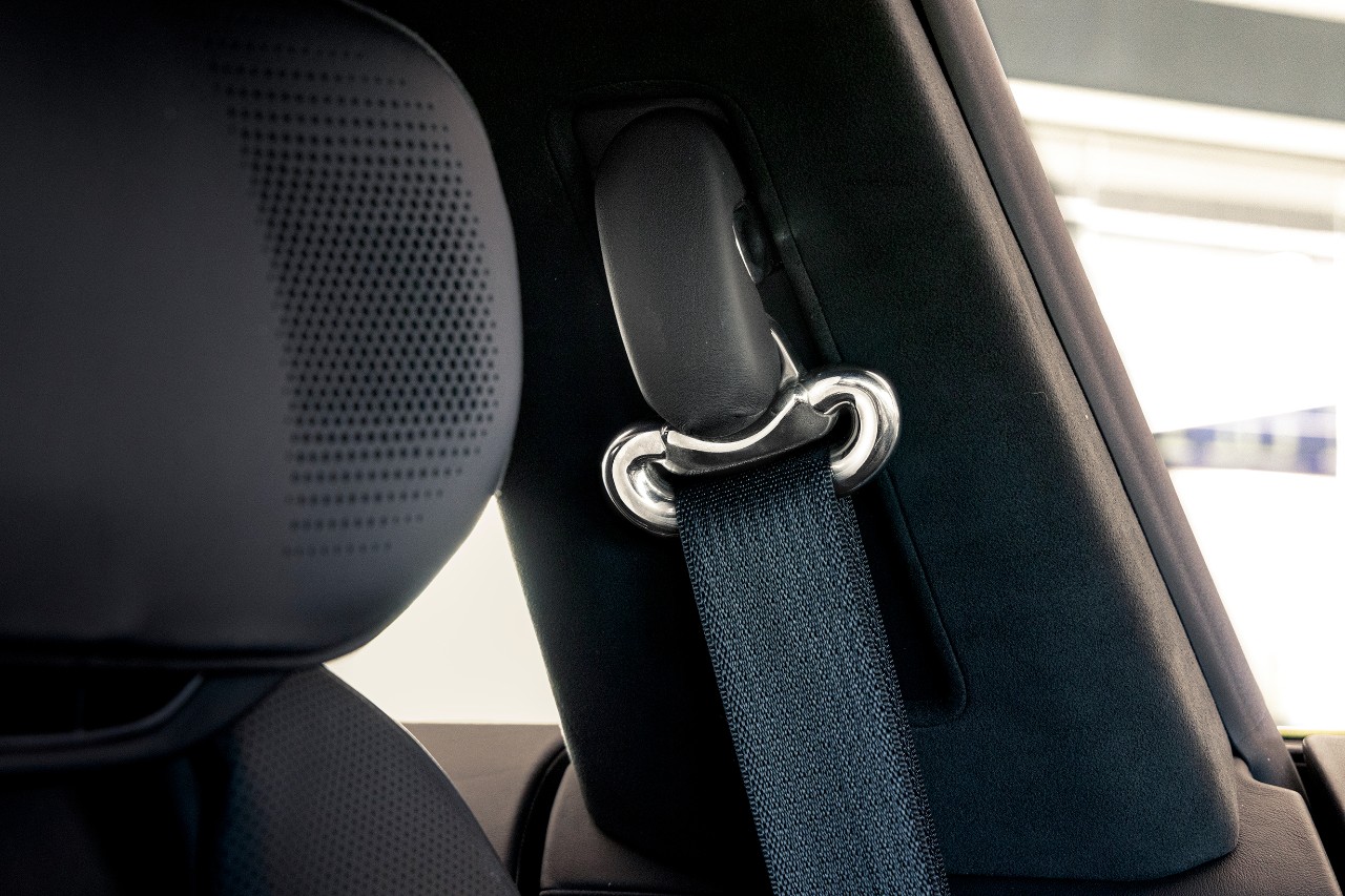 Seat Belt Adjustable Guide Loop - Cadillac CELESTIQ A metal seat belt loop inside a car