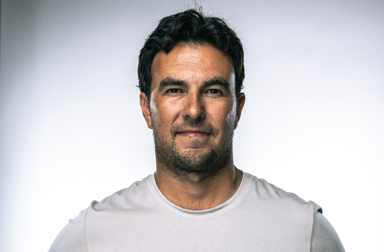 A silver convertible sports car parked near a scenic ocean vista.