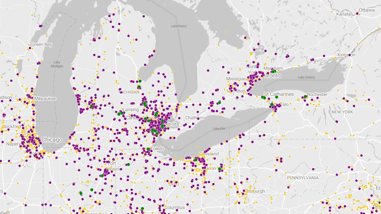 Man sitting in bed of pickup truck.