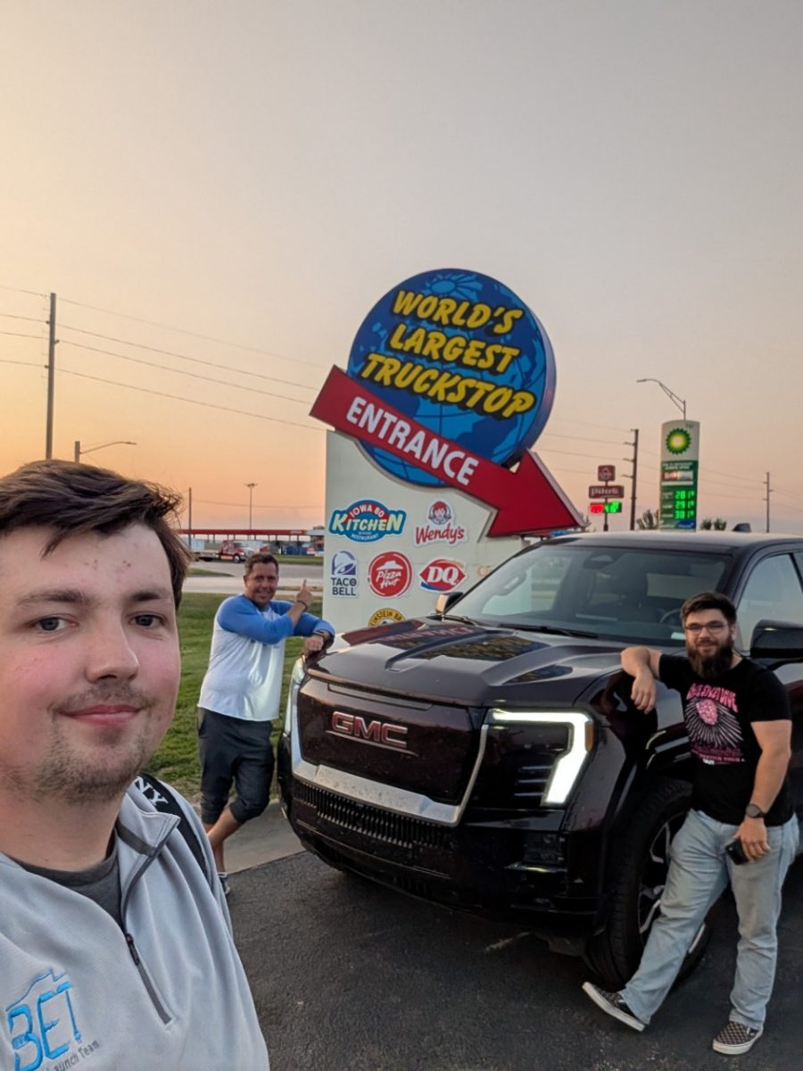 Three people in front of world's largest truck stop