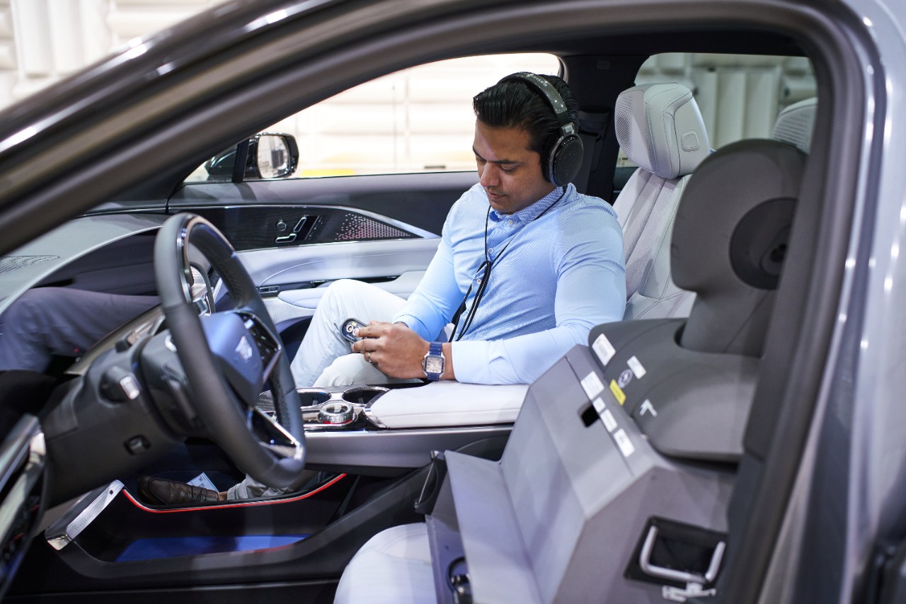 Jay Kapadia, GM’s creative sound director, sits in a Cadillac LYRIQ in the automaker’s sound design studio.