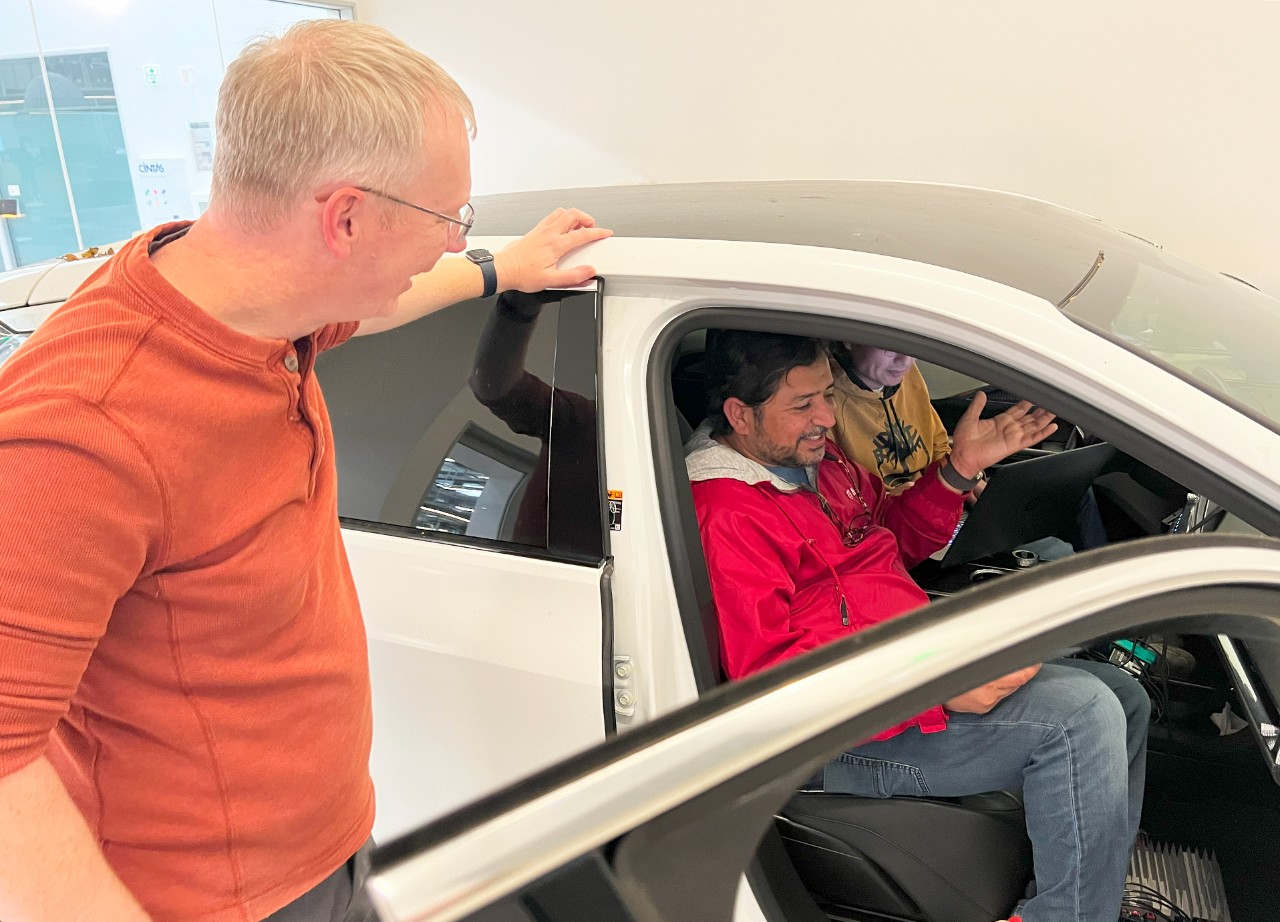 Graham (left) chats with engineers Vivek Dhankar (center) and Liangyi Zhao (right) at the Mountain View Tech Center as they