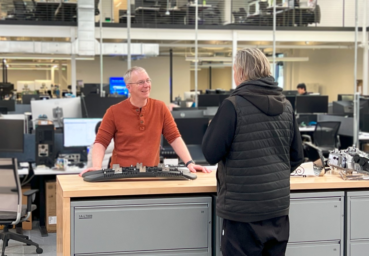 Graham (left) talks shop with software engineering quality director Dan Segall (right).