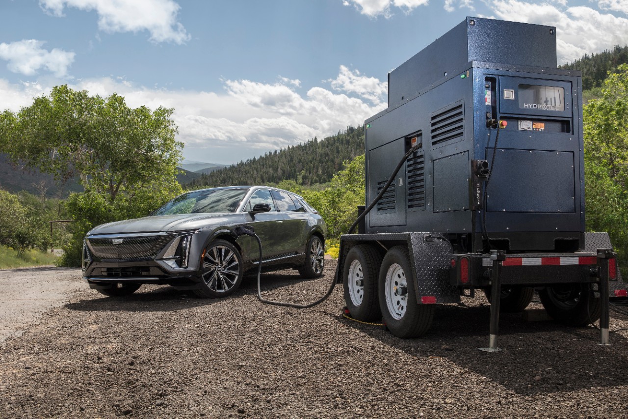 A GM HYDROTEC hydrogen-powered mobile charger, plugged into a Cadillac LYRIQ.