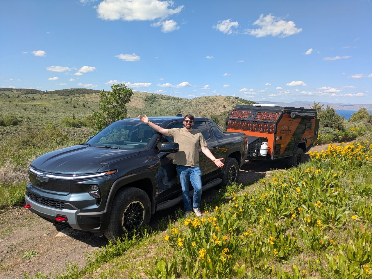 A Cadillac LYRIQ behind an EF Pro Cycling rider.
