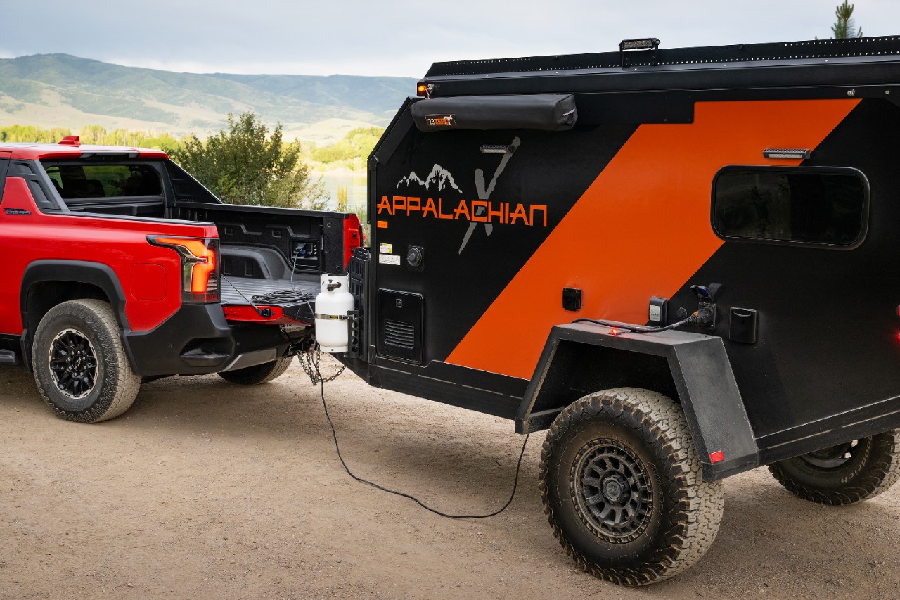 A Cadillac LYRIQ behind an EF Pro Cycling rider.