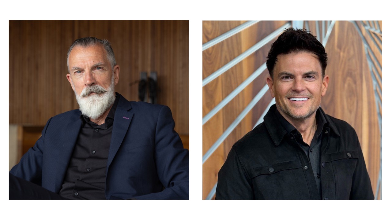A man standing in front of a desk.