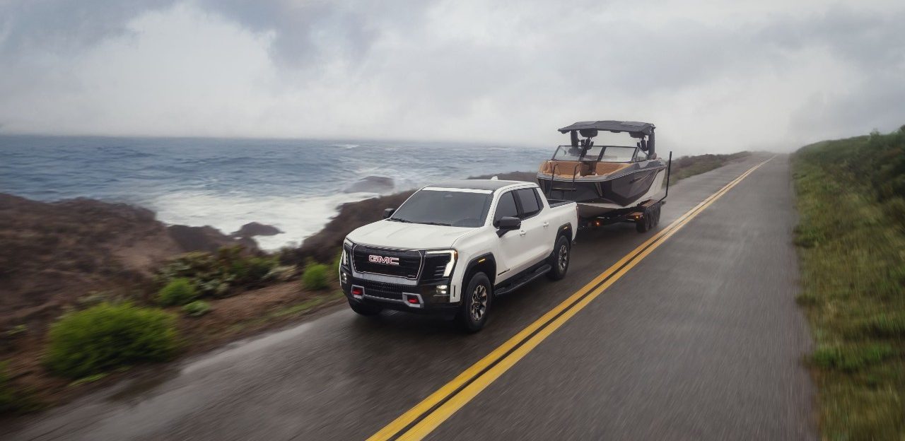A 2026 GMC Sierra EV towing a boat