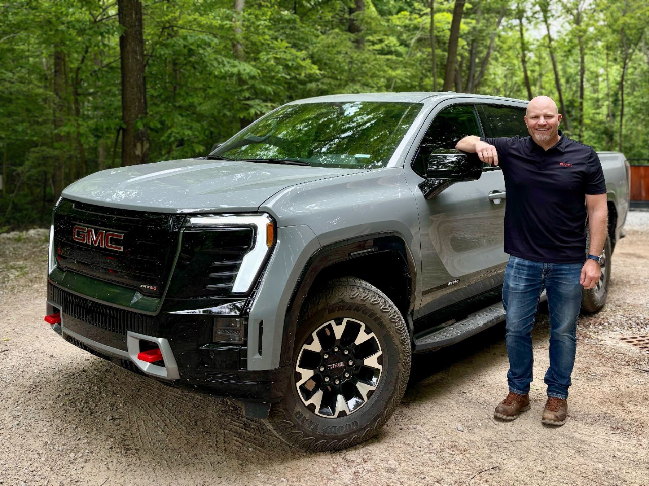 Man standing next pickup truck.