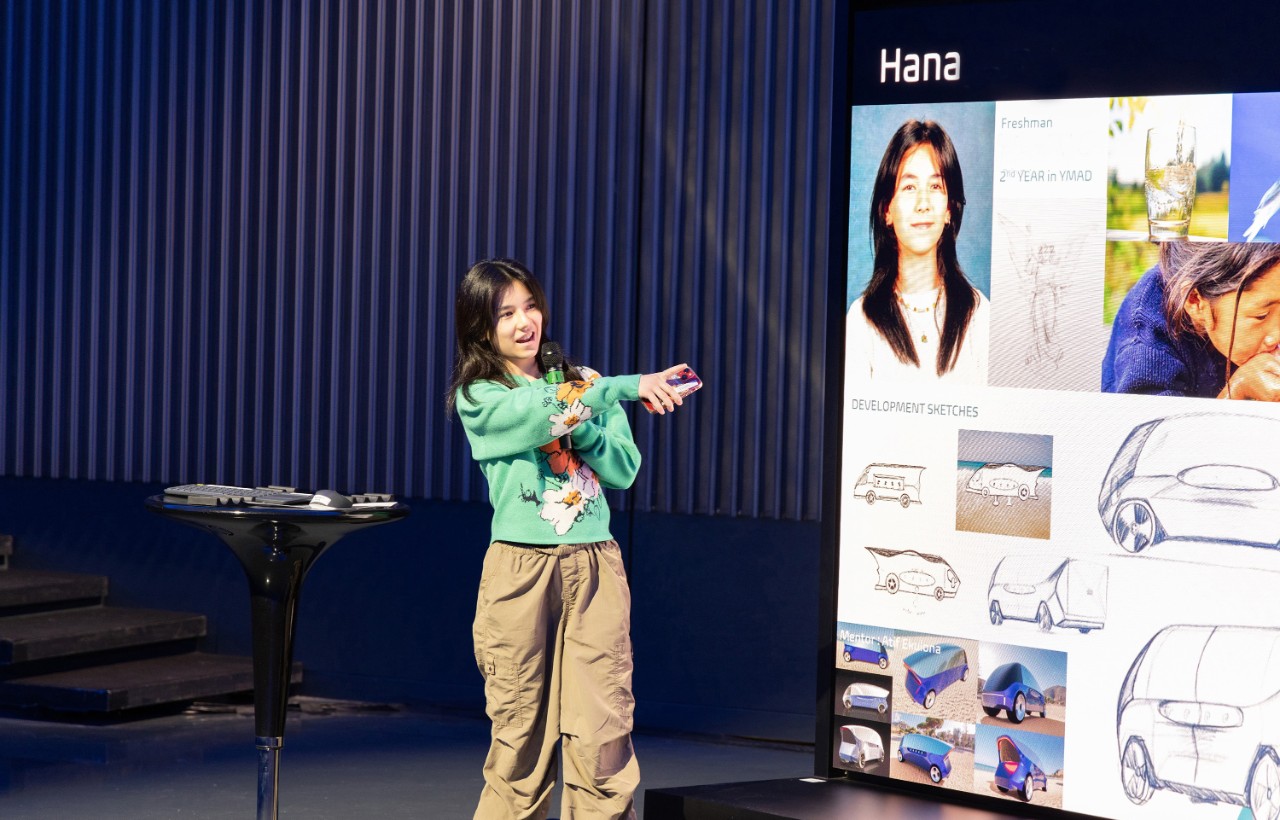 Student at showcase 2a Girl on stage giving a presentation.