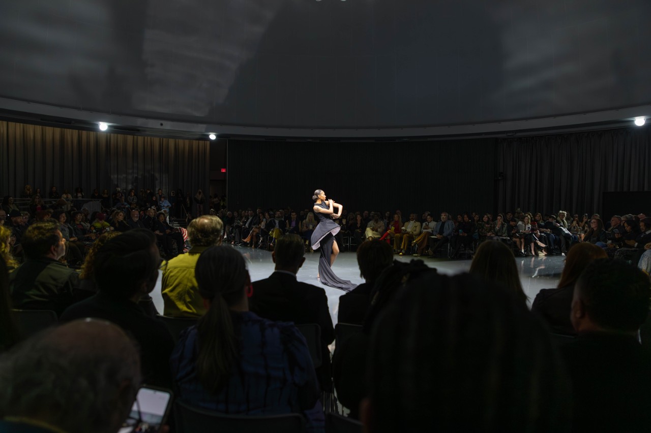 Woman in black dress on fashion runway
