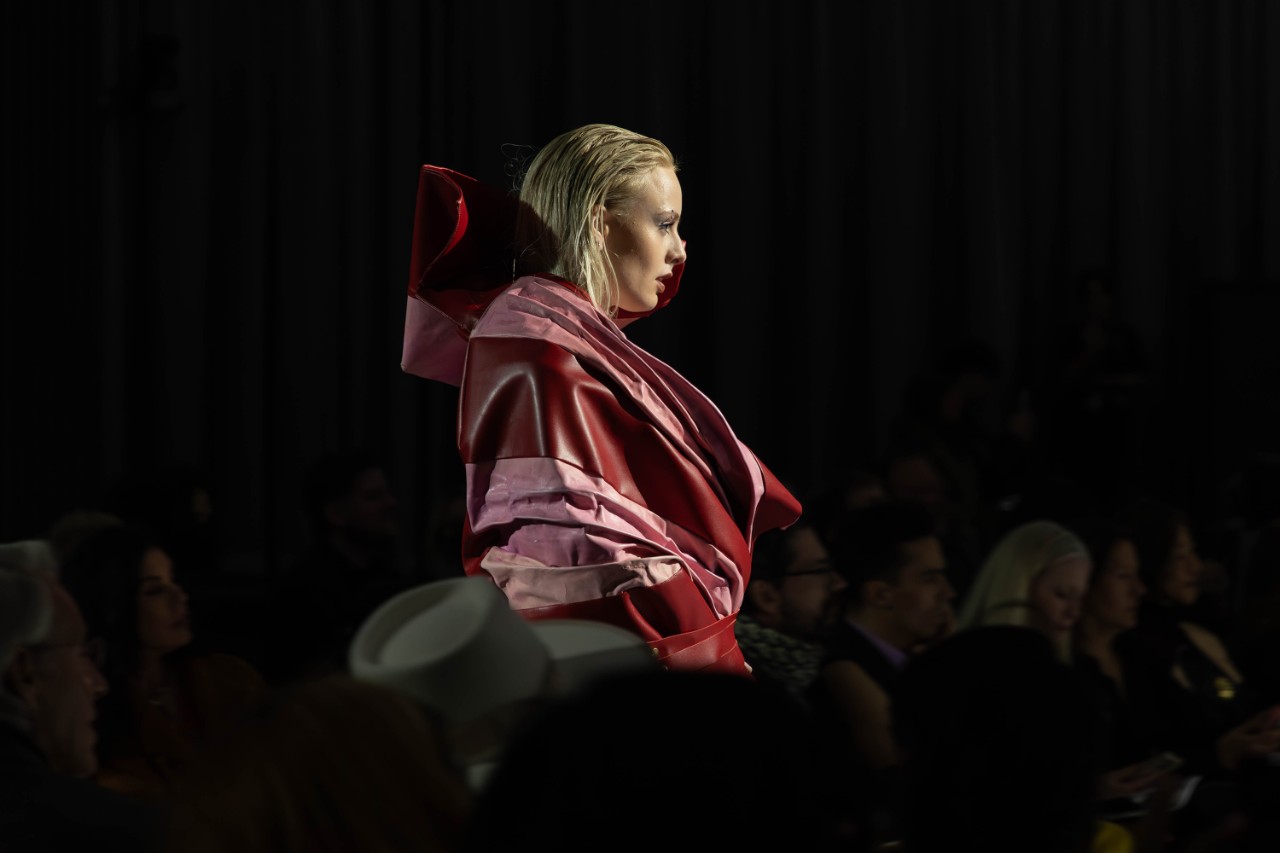 Close-up of woman in red dress on fashion runway