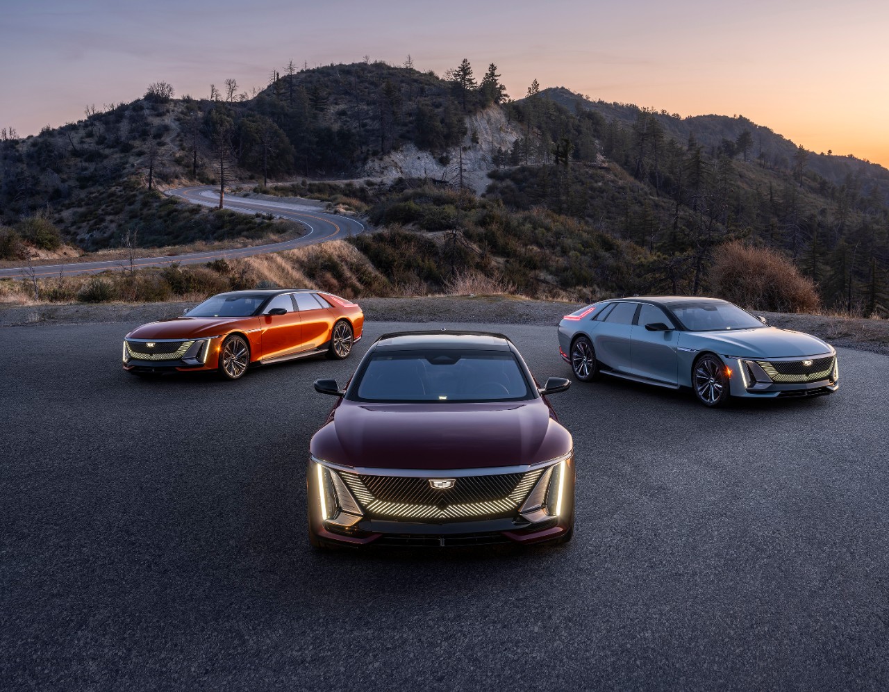 Three Cadillac Celestiqs parked on a mountain road.