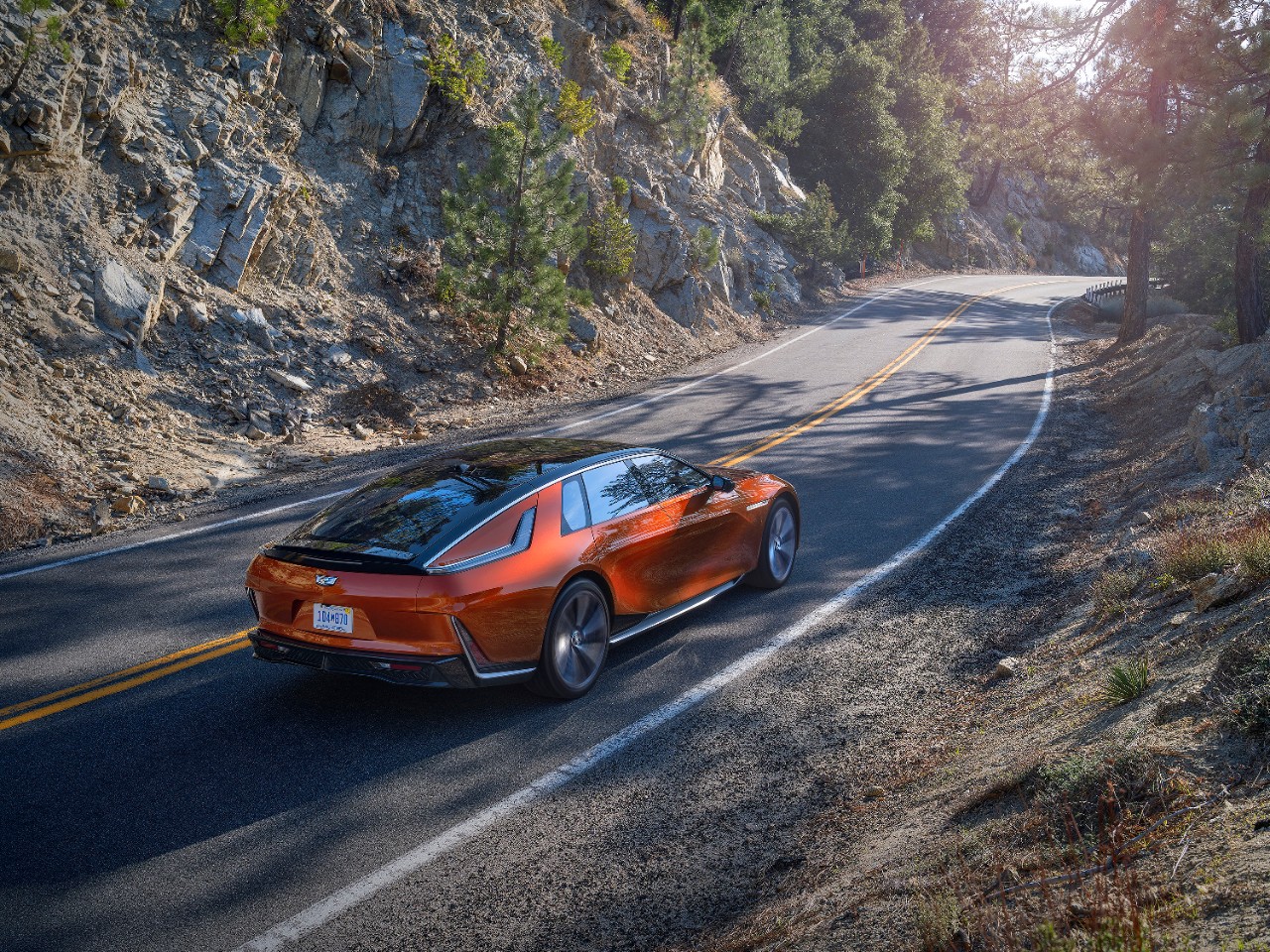 Orange Cadillac Celestiq on country road.