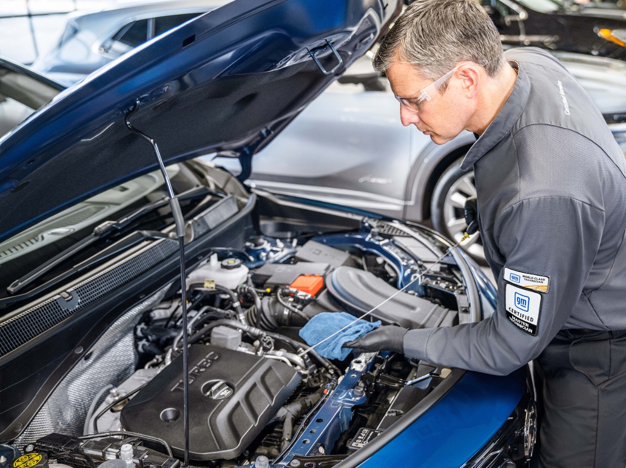 A GM-trained technician works on an engine.