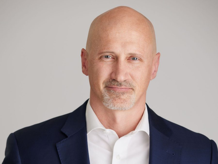 A Cadillac in front of a Secret Service sign.