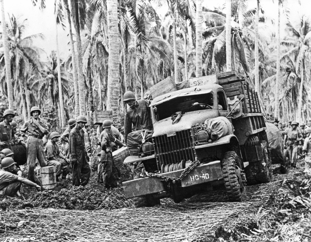 CCKW truck driving in a jungle environment.