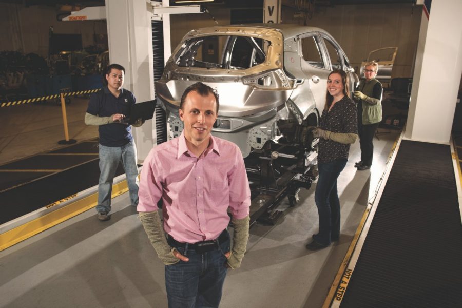 Man standing in front of red car