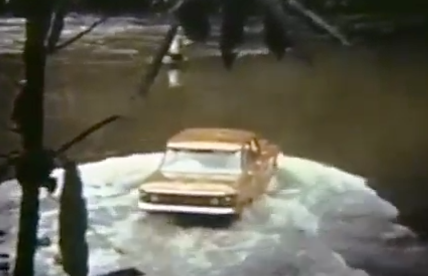 A Corvair crossing a river, rear view.