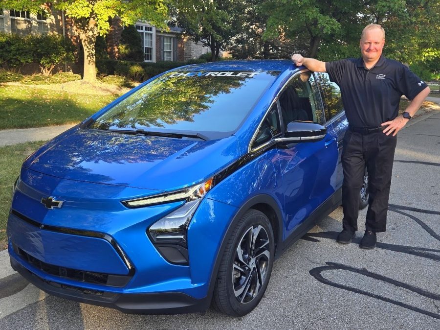 Man standing next to Chevy Bolt