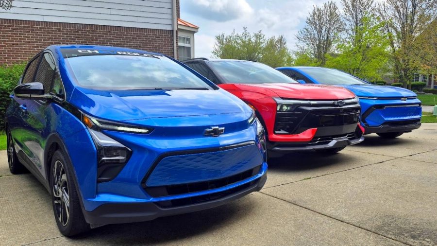 Bo1 Three Chevy EVs in a driveway.