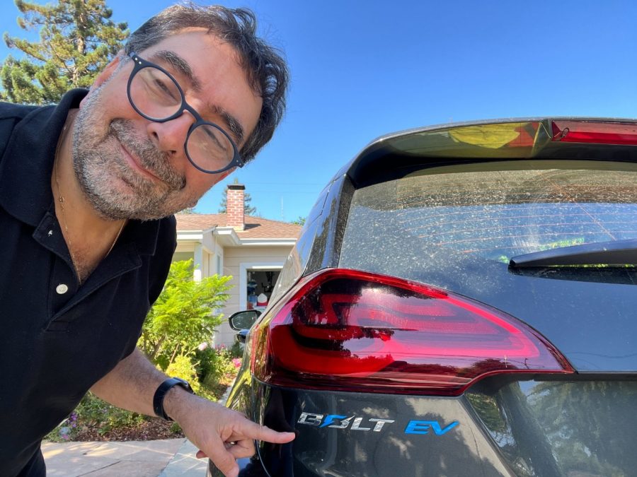 Man standing in front of red car