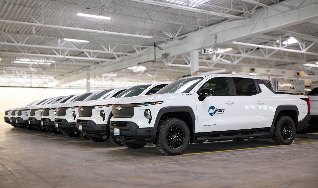 A row of McKinstry’s Chevrolet Silverado EV fleet trucks.