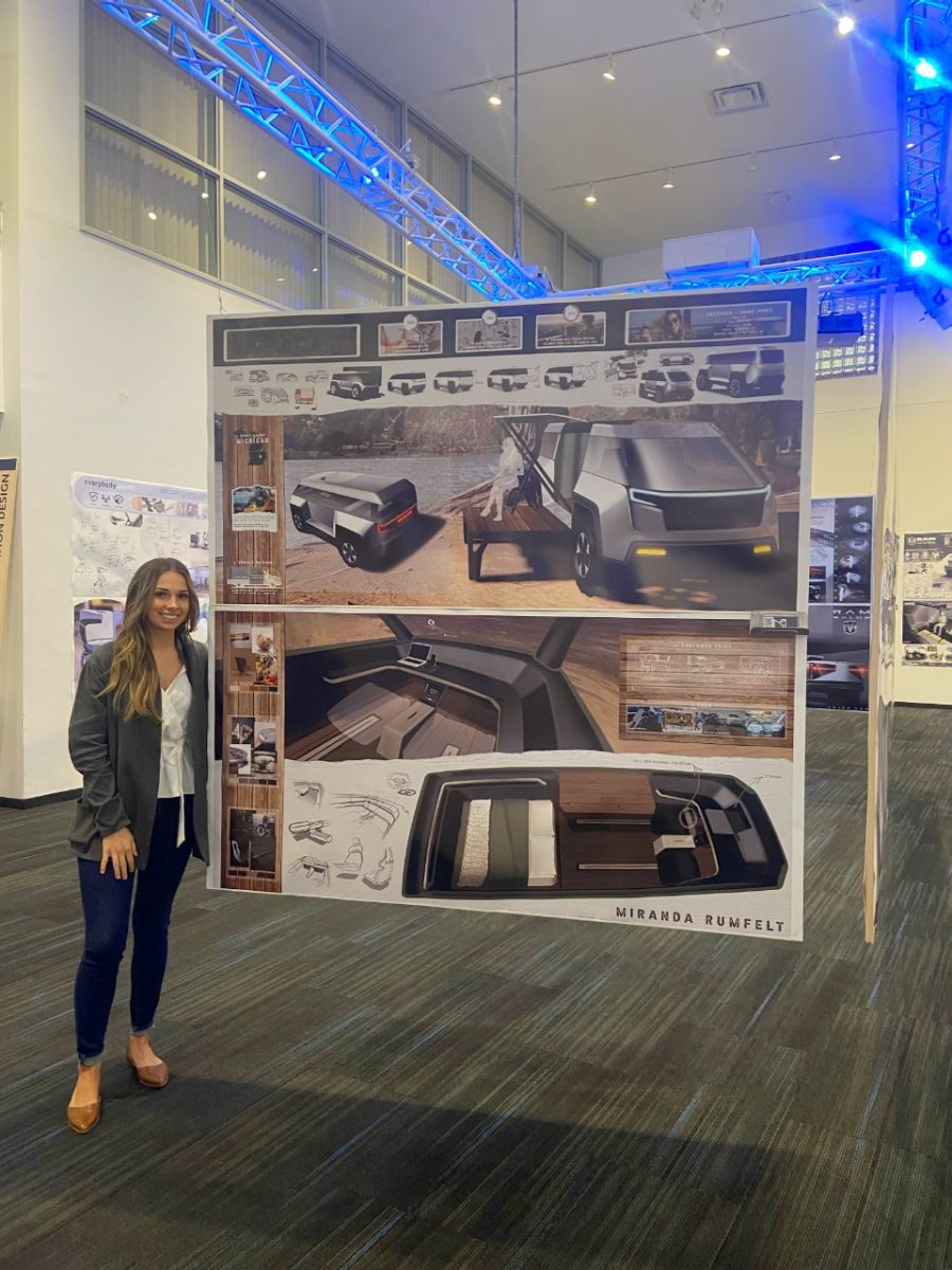 Car designer in front of large sketches.