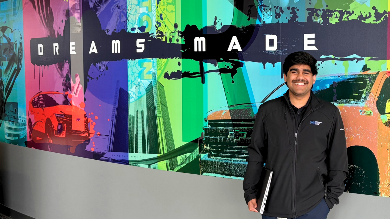 At GM’s Warren Tech Center, Vir Dasgupta stands in front of a mural that reflects the future-focused spirit of his work.