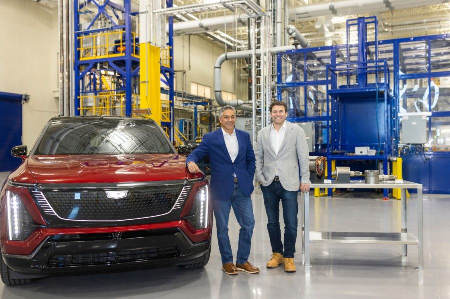 Two men stand in a manufacturing facility