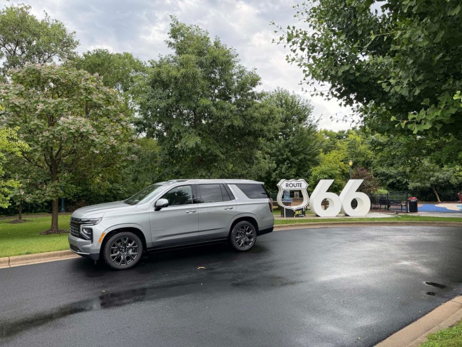 Silver Chevrolet Tahoe next to a Route 66 logo