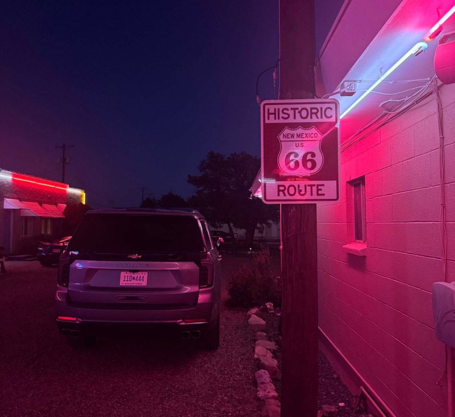Chevrolet Tahoe next to a Route 66 sign on pole