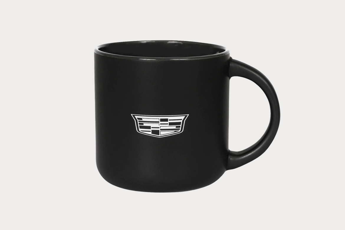 Black Ceramic Mug with Sleek Design and White Cadillac Logo on Front.