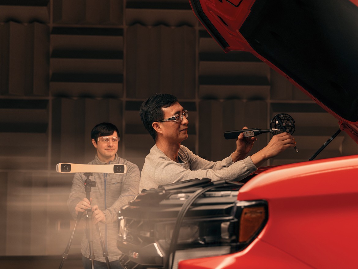 Close-up of Two Team Members with Goggles on Working on Filming a Shot with a GM Vehicle