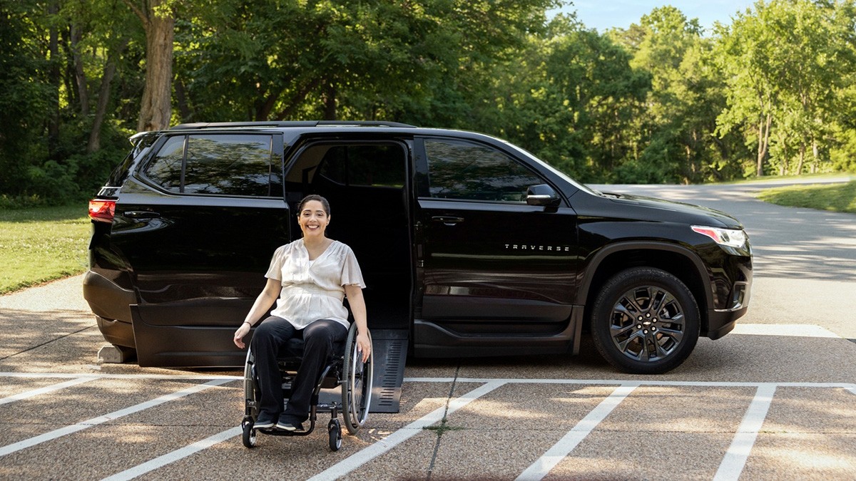 A woman in a wheelchair coming out of a Traverse 