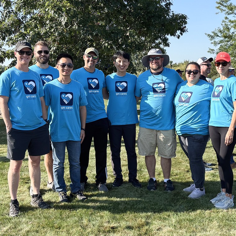 A Group Picture of GM Employees in Blue T-shirts that Volunteered for a GM Cares Event